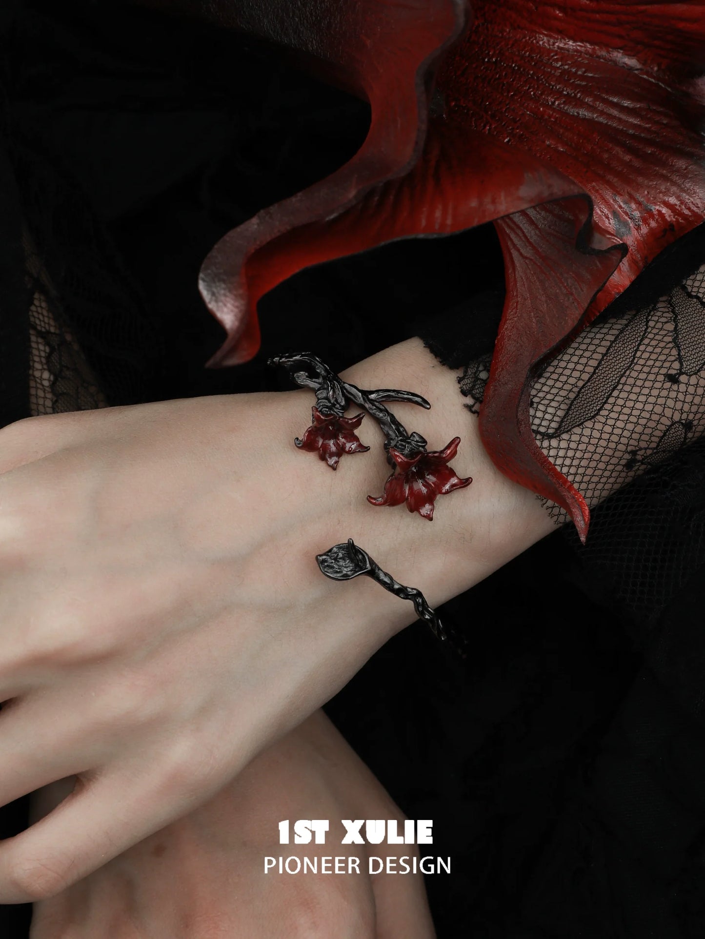Gothic mandala bracelet featuring red floral charms on a textured black band for dark fashion enthusiasts