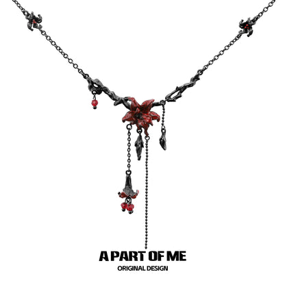 A PART OF ME gothic mandala necklace featuring intricate black chains and red floral accents