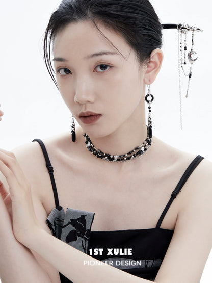 Model wearing gothic nightfall pendant earrings paired with elegant dark attire