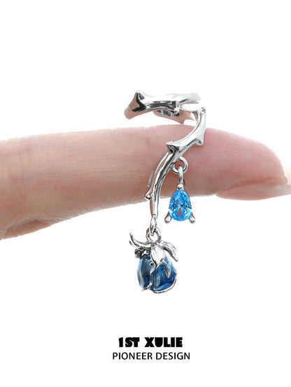 Gothic rose ear cuffs with blue gemstone drops on a silver branch design