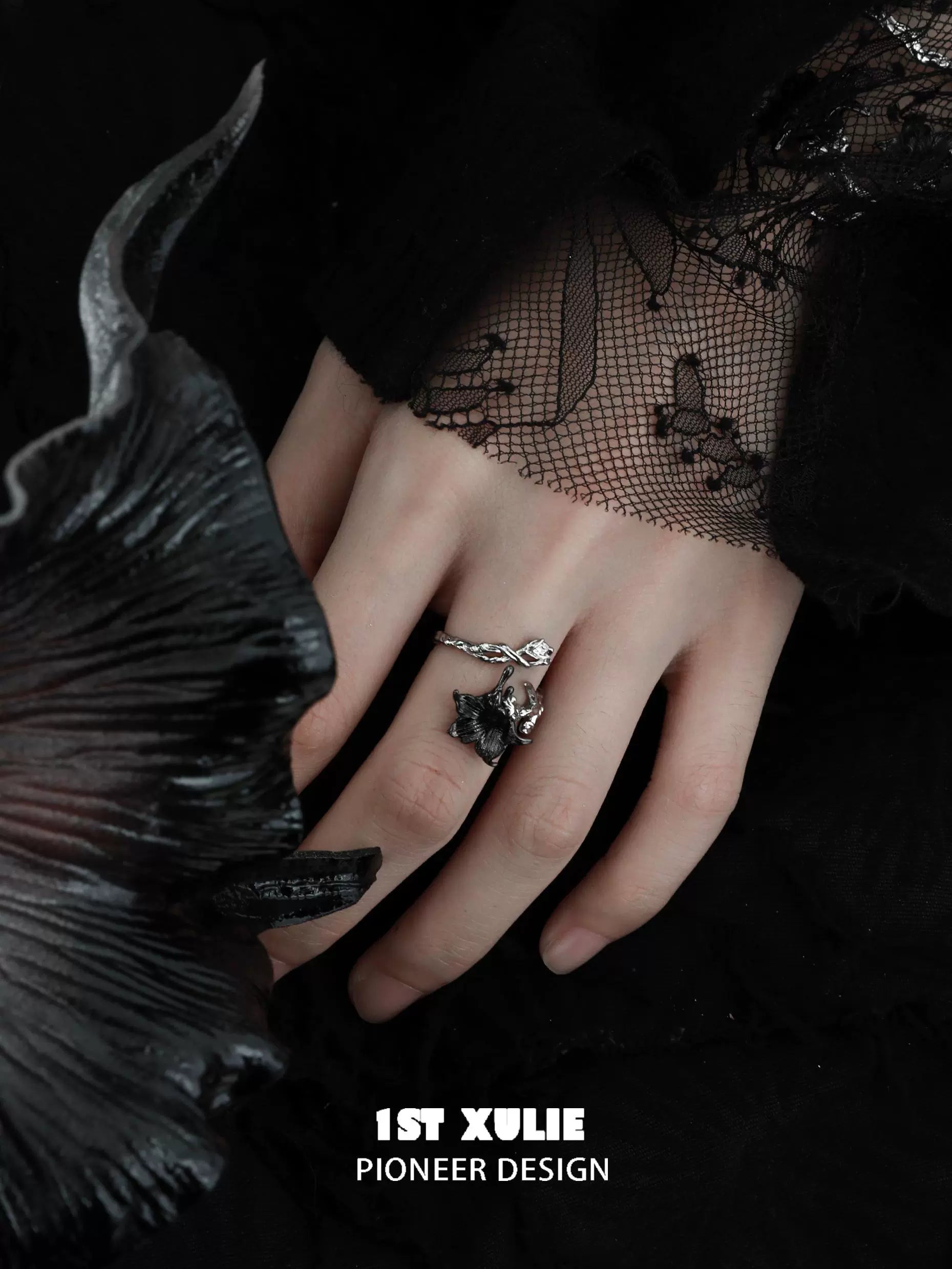 Gothic silver mandala ring displayed on a hand with artistic black lace and floral accents