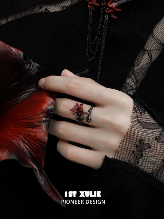 Gothic silver mandala ring featuring detailed design worn on a hand with dark red accents