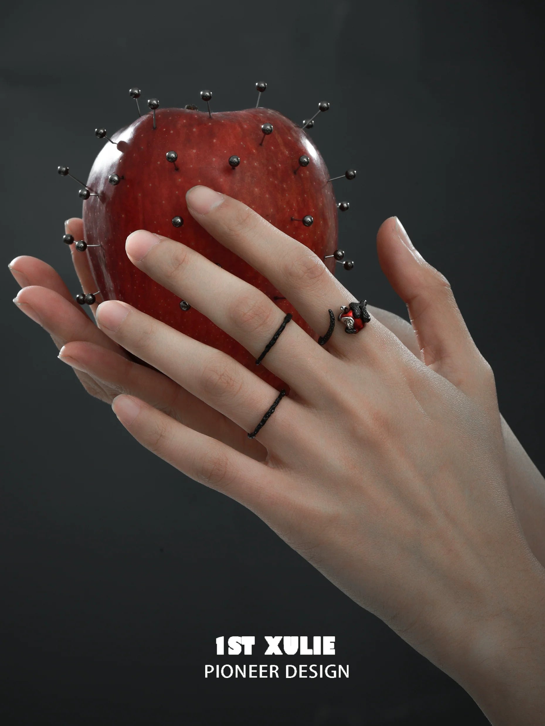 Gothic snake apple ring displayed on hand with a decorative apple for a dramatic look