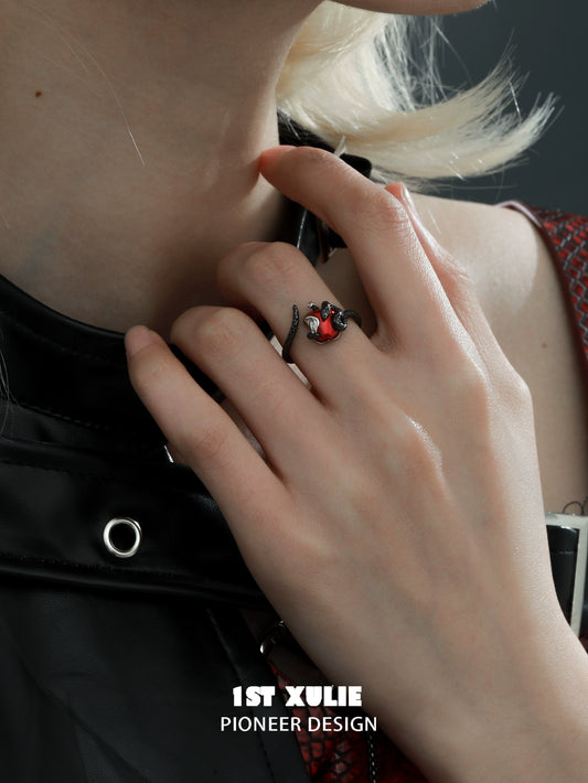Gothic snake apple ring displayed on a hand, featuring intricate design and vibrant colors