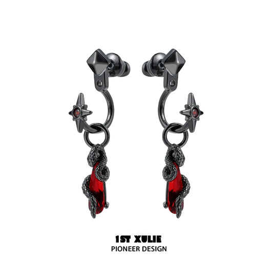 Gothic snake earrings designed by 1STXULIE featuring red accents and star details.