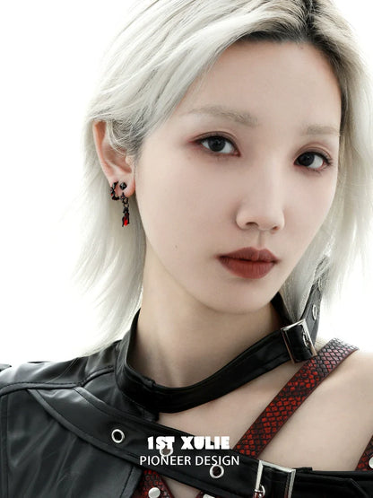 Model wearing gothic snake earrings with intricate detailing and gothic style design
