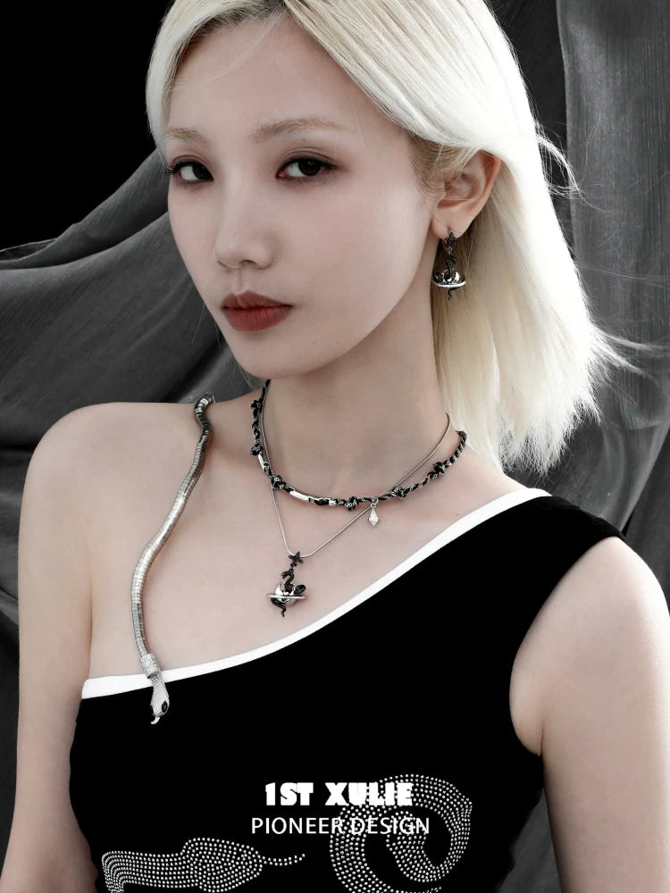 Stylish model wearing a gothic snake necklace layered with silver chains for a trendy look