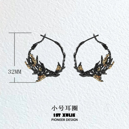 Gothic swallow earrings in black and gold design, featuring a unique twisted hoop shape