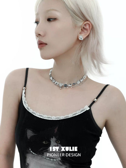 Stylish woman wearing a graffiti cat necklace with matching earrings for trendy accessory lovers