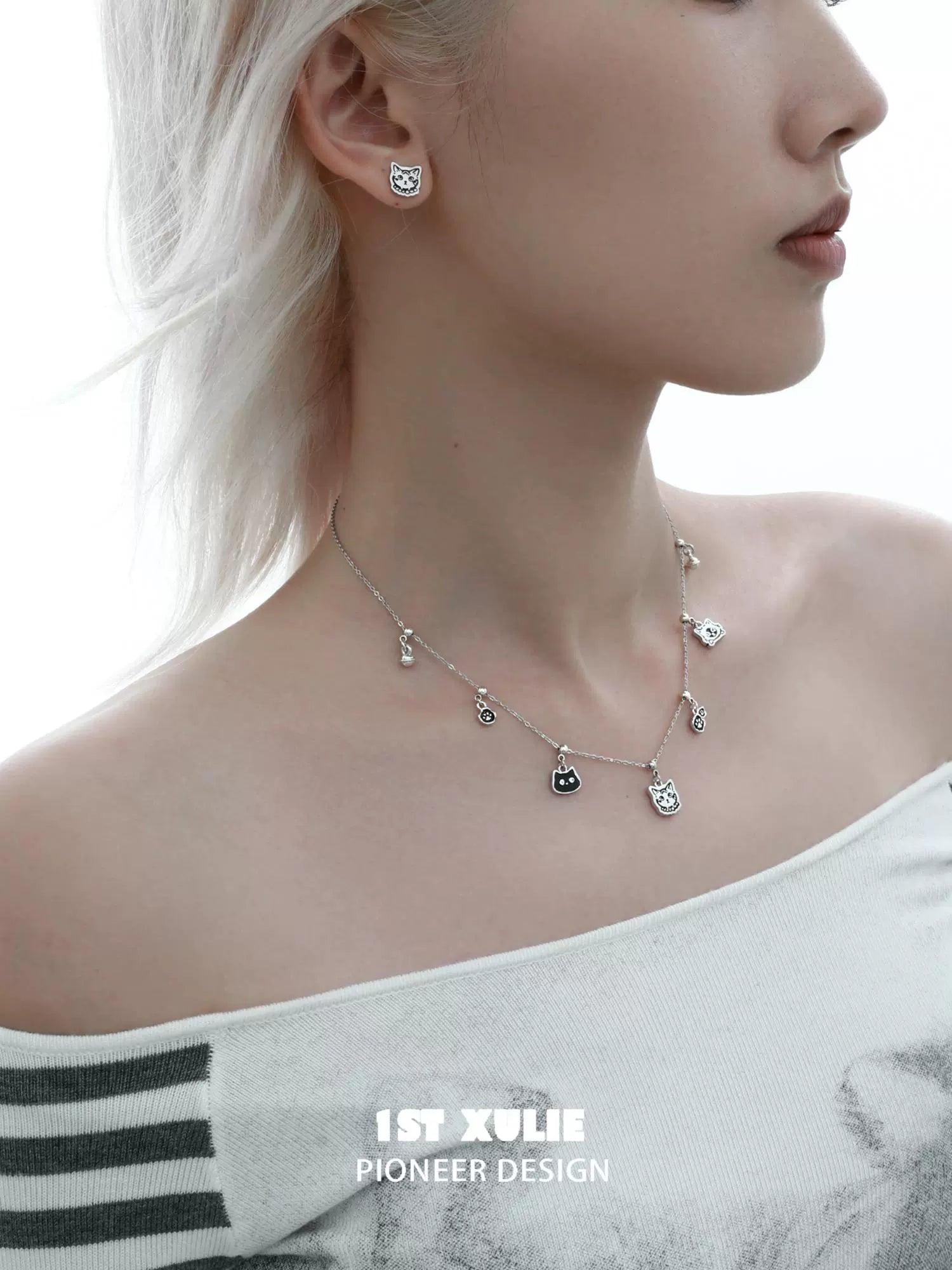 Graffiti cat sterling silver necklace featuring playful cat-shaped charms and matching earrings