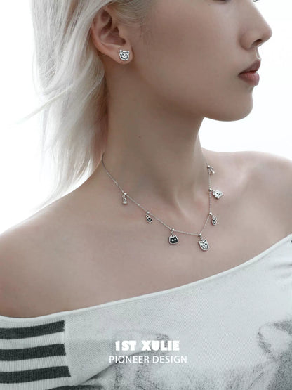 Graffiti cat sterling silver necklace featuring playful cat-shaped charms and matching earrings