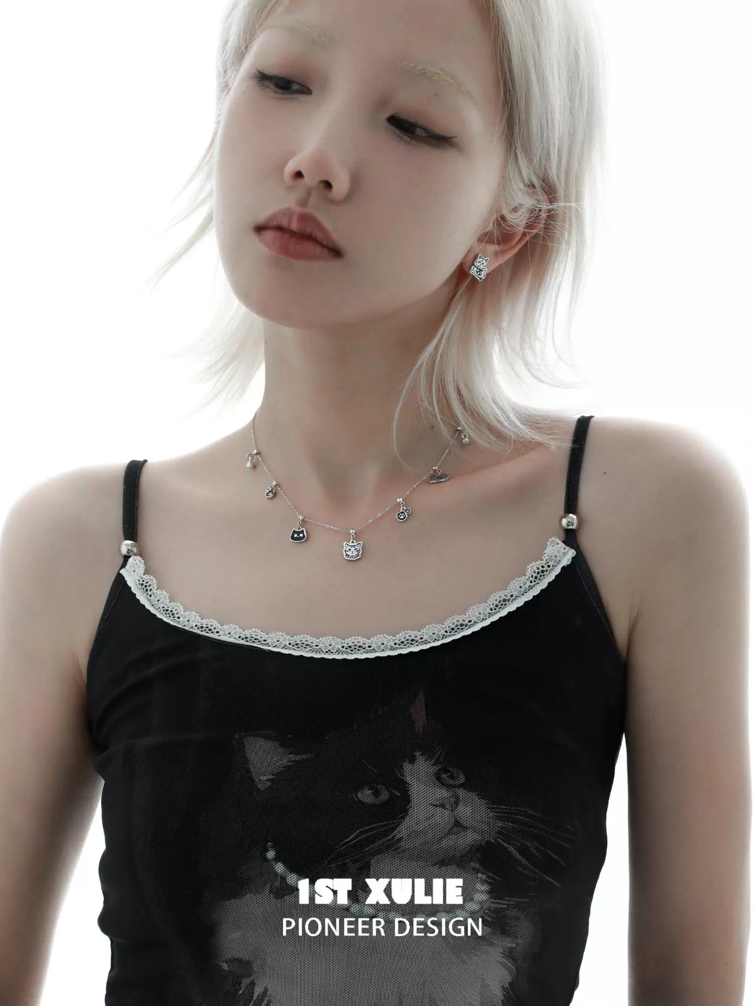 Stylish graffiti cat sterling silver necklace worn by a model with a black outfit