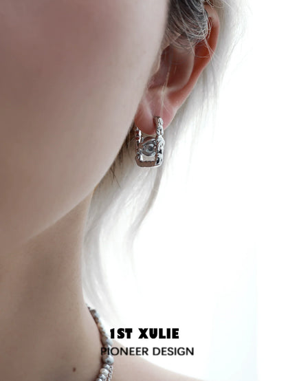 Stylish gray pearl star earrings displayed on a model's ear for a chic look