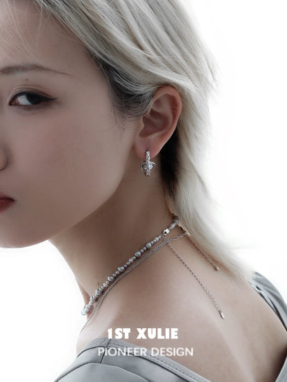 Elegant gray pearl star earrings with a unique design worn by a model showcasing modern jewelry