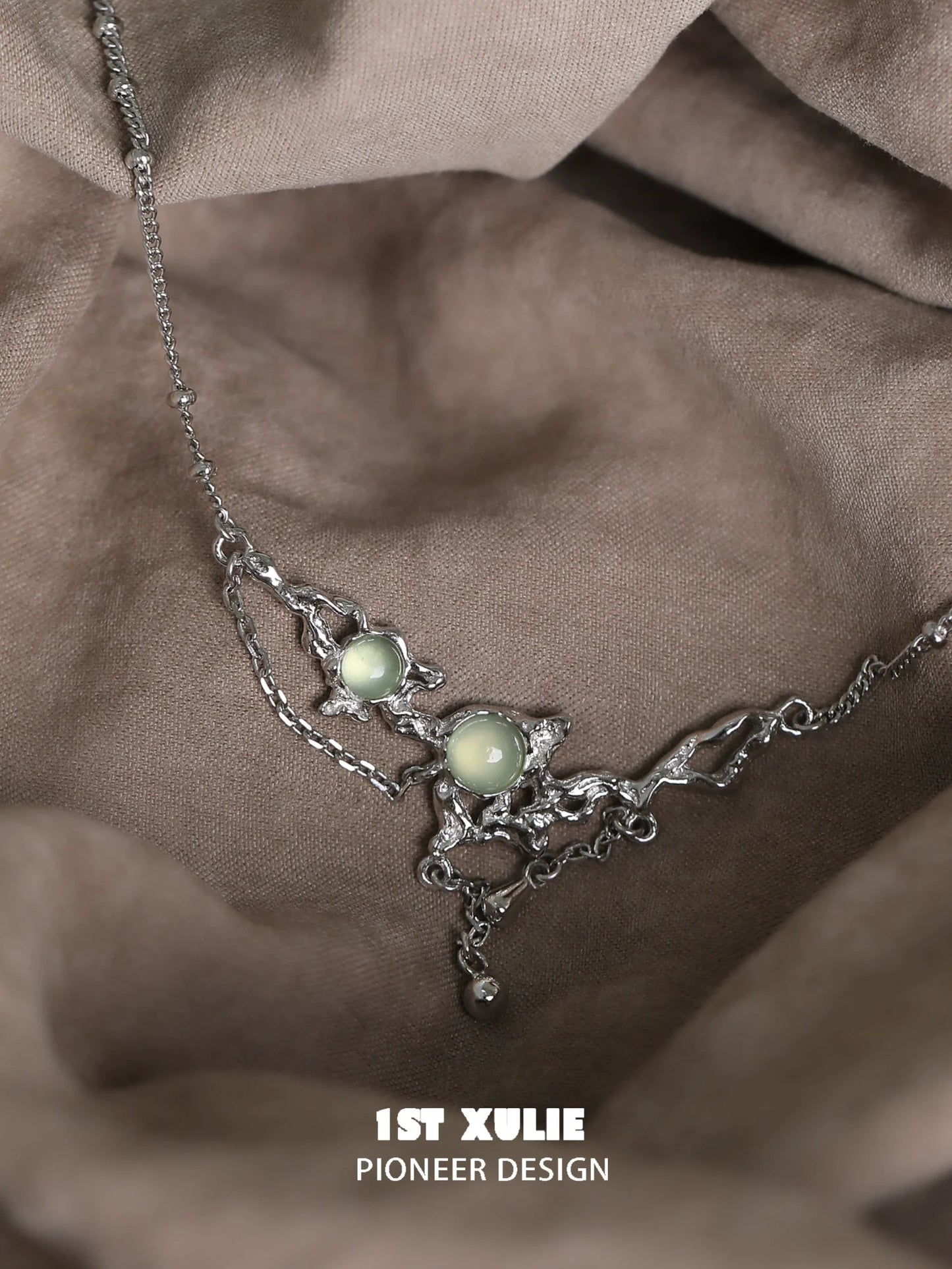Stylish green gem silver necklace featuring unique design with two green gems and intricate silver details
