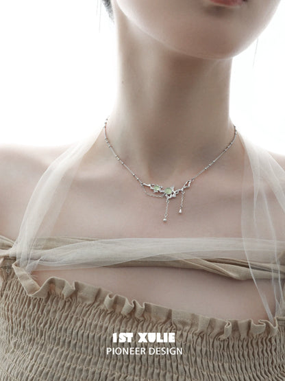 Elegant green gem silver necklace featuring a unique design and delicate details