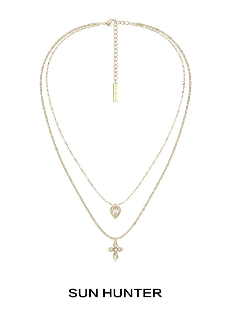 SUN HUNTER heart cross double layer necklace in gold with a heart and cross pendant