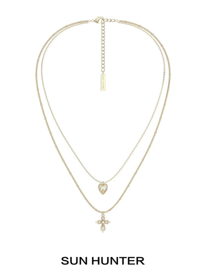 SUN HUNTER heart cross double layer necklace in gold with a heart and cross pendant