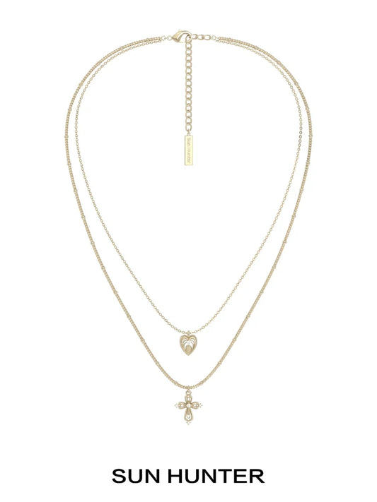 SUN HUNTER heart cross double layer necklace in gold with a heart and cross pendant