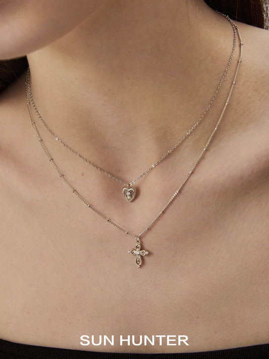SUN HUNTER heart cross double layer necklace featuring a heart pendant and cross charm for elegant layering