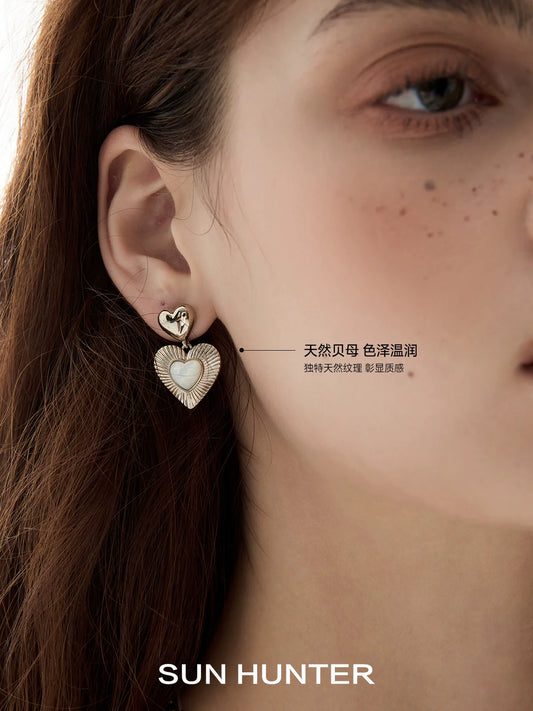 Stylish heart shaped statement earrings from SUN HUNTER featuring a unique design and elegant finish