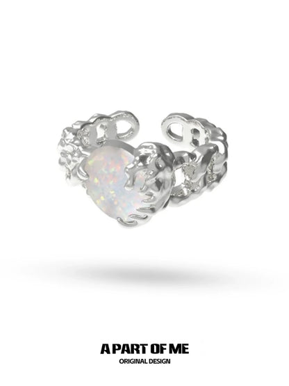 A PART OF ME heart vow ring with a silver design and an opalescent heart-shaped gemstone