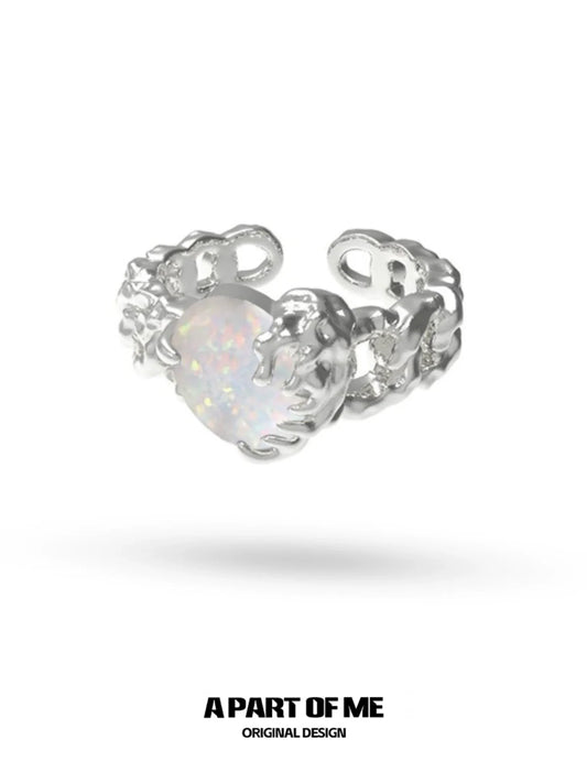 A PART OF ME heart vow ring with a silver design and an opalescent heart-shaped gemstone