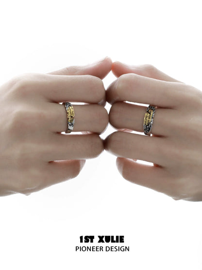 Two hands wearing the Immortal Love Letter silver ring featuring unique engraving design