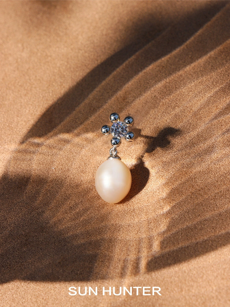 Elegant island flower pearl earrings featuring a floral design with a shimmering pearl drop