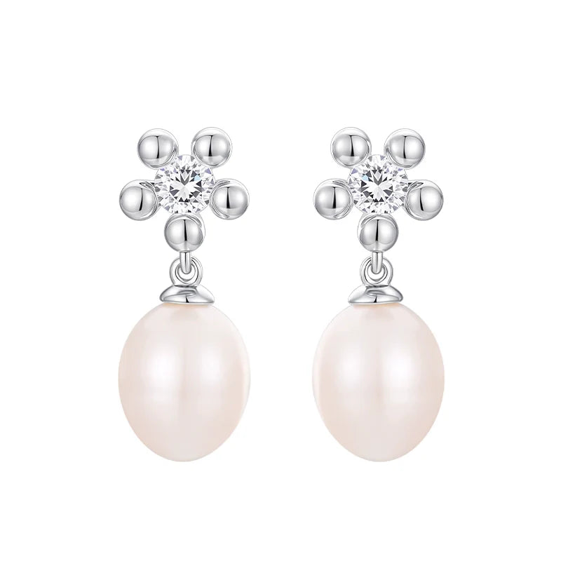 Elegant SUN HUNTER island flower pearl earrings with sparkling accents and lustrous pearls