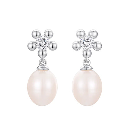 Elegant SUN HUNTER island flower pearl earrings with sparkling accents and lustrous pearls