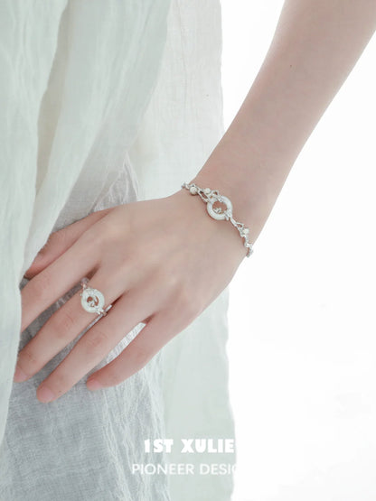 Elegant jade rabbit white agate silver bracelet showcased on wrist with matching ring from 1STXULIE