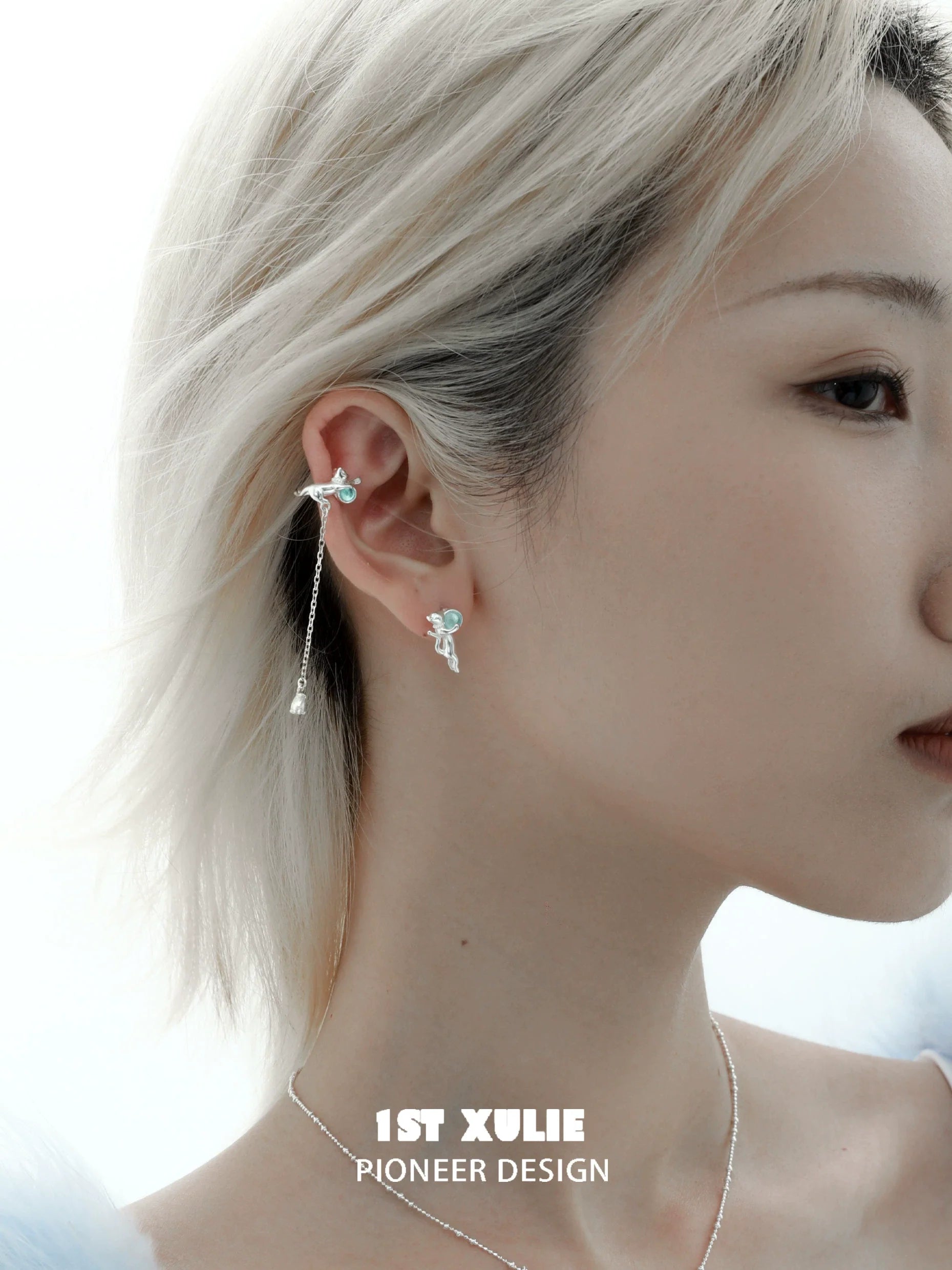 Stylish silver kitten ear cuff jewelry adorning a model's ear with a delicate design