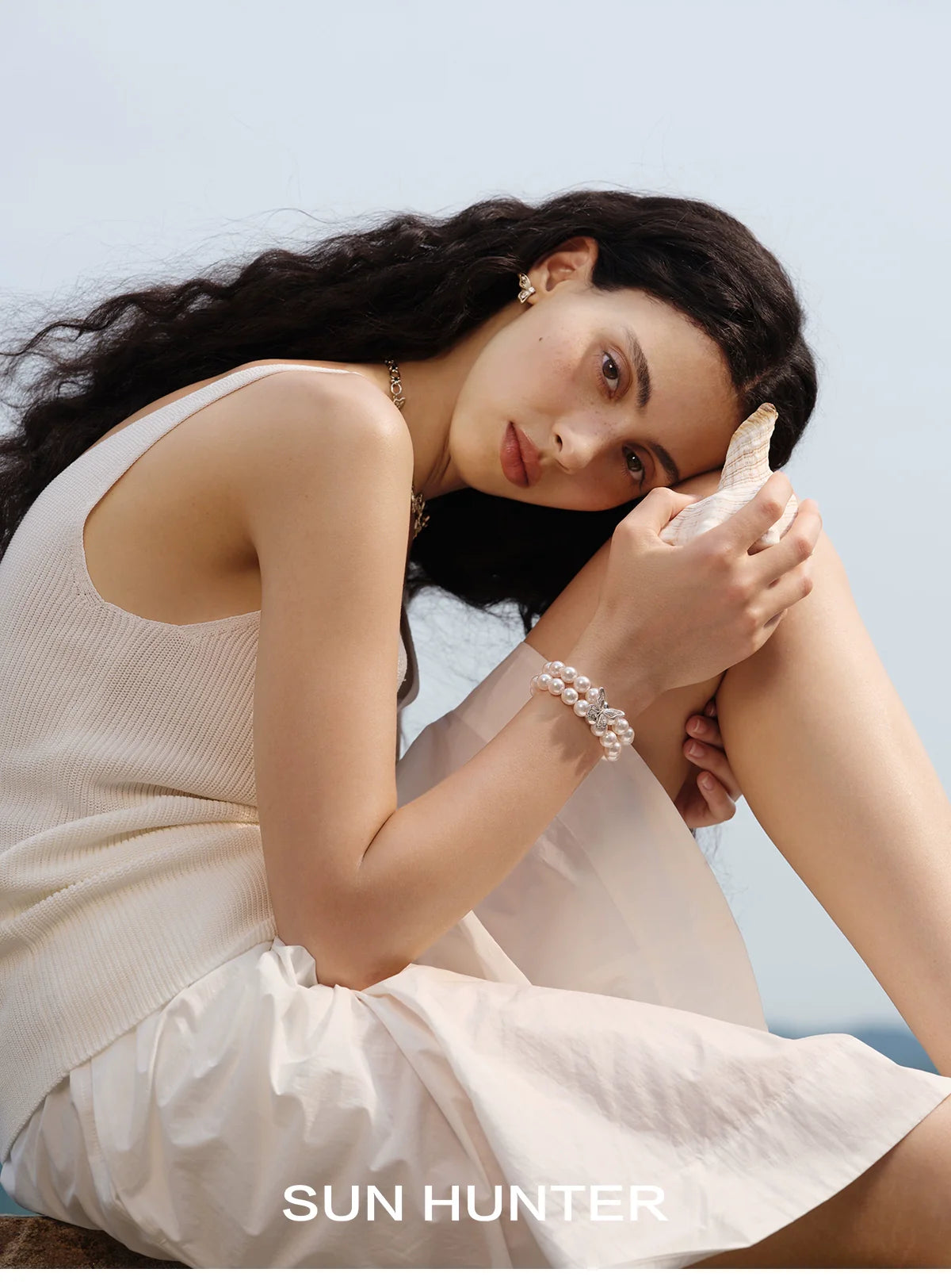 Elegant lace butterfly pearl bracelet worn by a model, showcasing its delicate design and charm