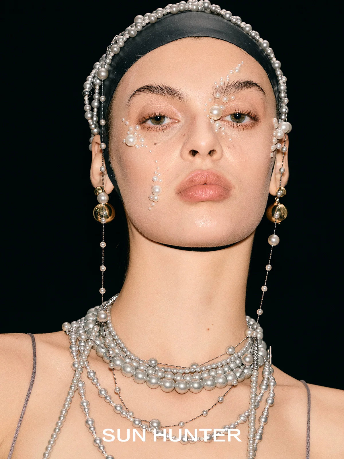 Layered pearl bracelet by SUN HUNTER featuring multiple strands of elegant pearls for a sophisticated look