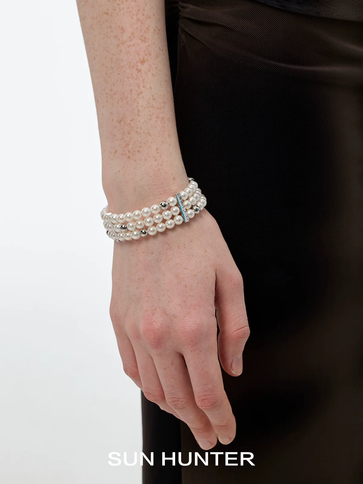 Elegant layered pearl bracelet from SUN HUNTER with multiple strands for a sophisticated look
