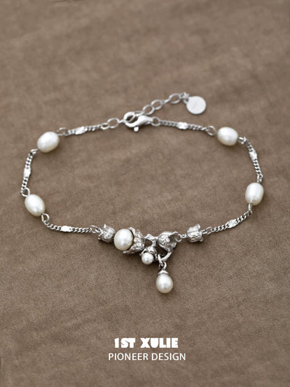 Elegant lily of the valley pearl bracelet featuring silver accents and a delicate design