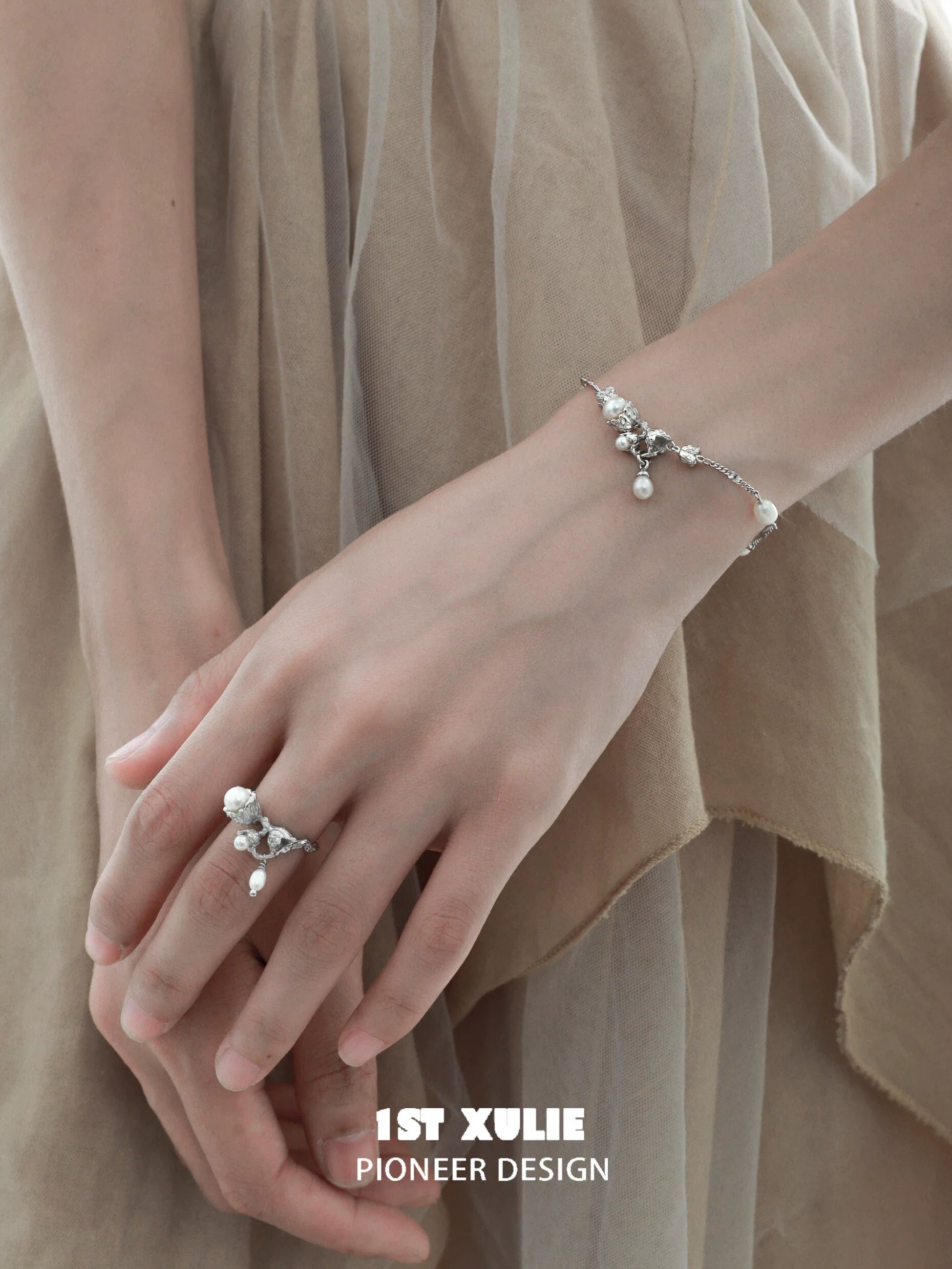 Elegant lily of the valley pearl bracelet on a model's wrist showcasing delicate floral design