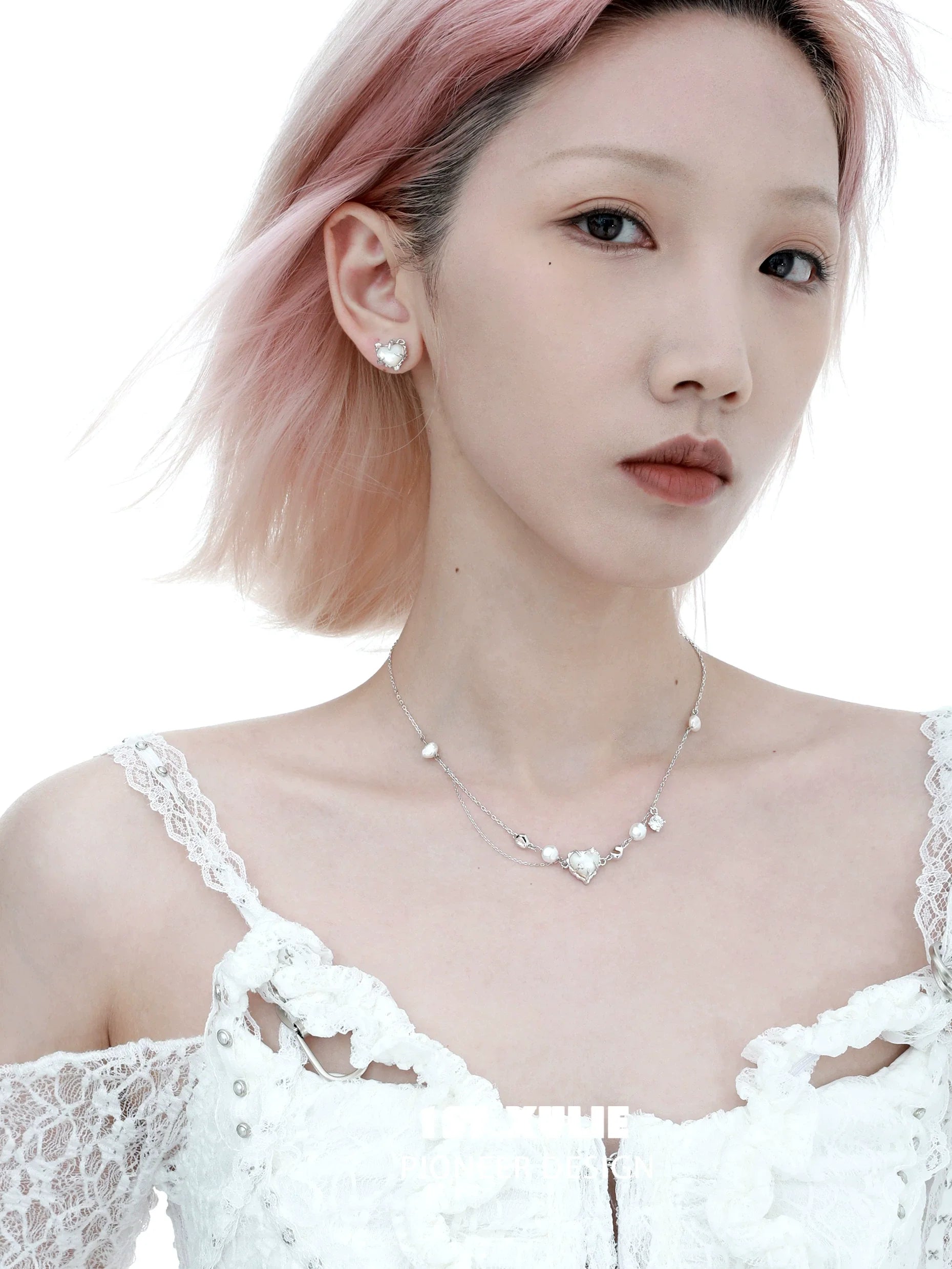 Model wearing a love fritillary silver necklace with heart-shaped pendant and sparkling accents