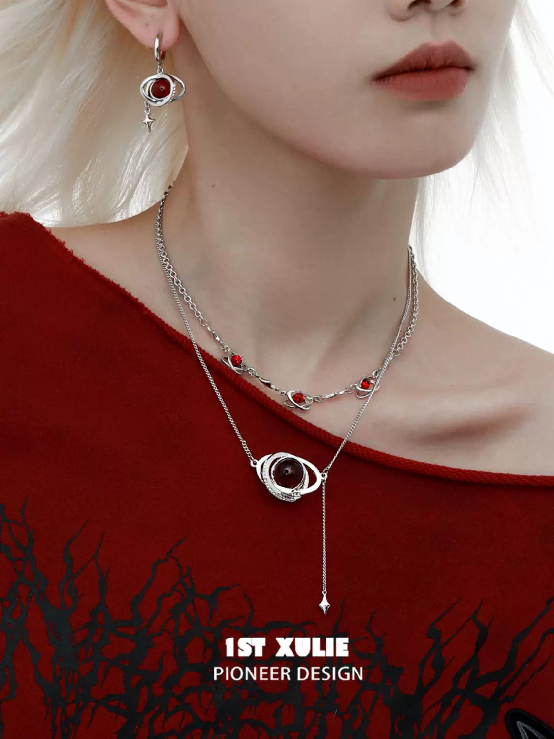 Silver mars inspired necklace with red gemstones showcased on a model wearing a stylish outfit