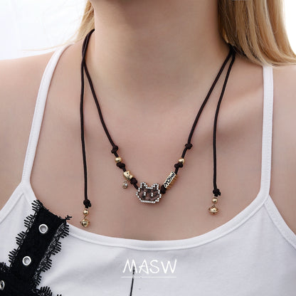 MASW jewelry mosaic pixel cat earrings from Gothhalo Jewelry displayed on a model wearing a stylish top