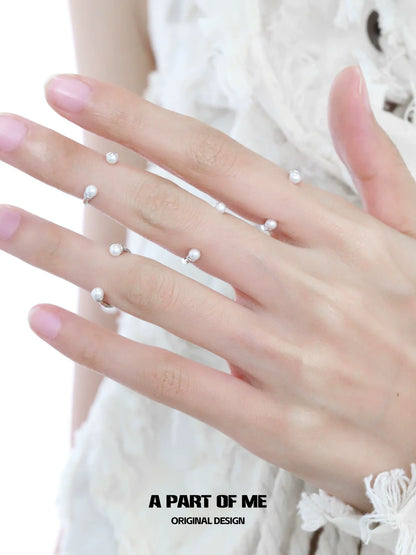 Stylish minimal pearl ring on hand, featuring delicate pearls for an elegant look by A PART OF ME