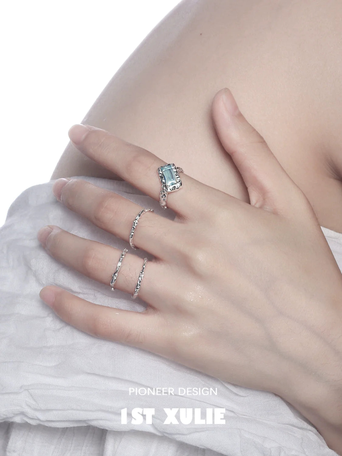 Minimalist silver ring showcased on a model's hand with a delicate turquoise stone
