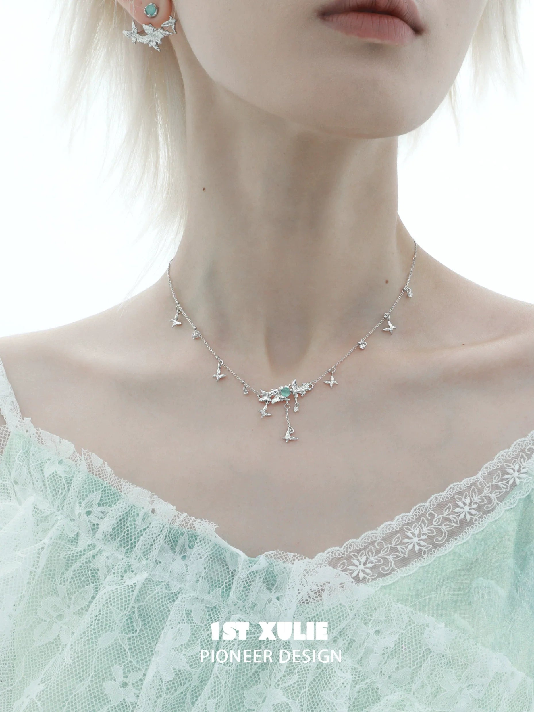 Mint butterfly necklace with delicate design, featuring sparkling accents for an elegant look