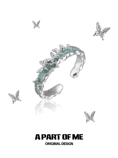 A Part of Me mint butterfly ring featuring delicate butterfly designs and a shimmering finish