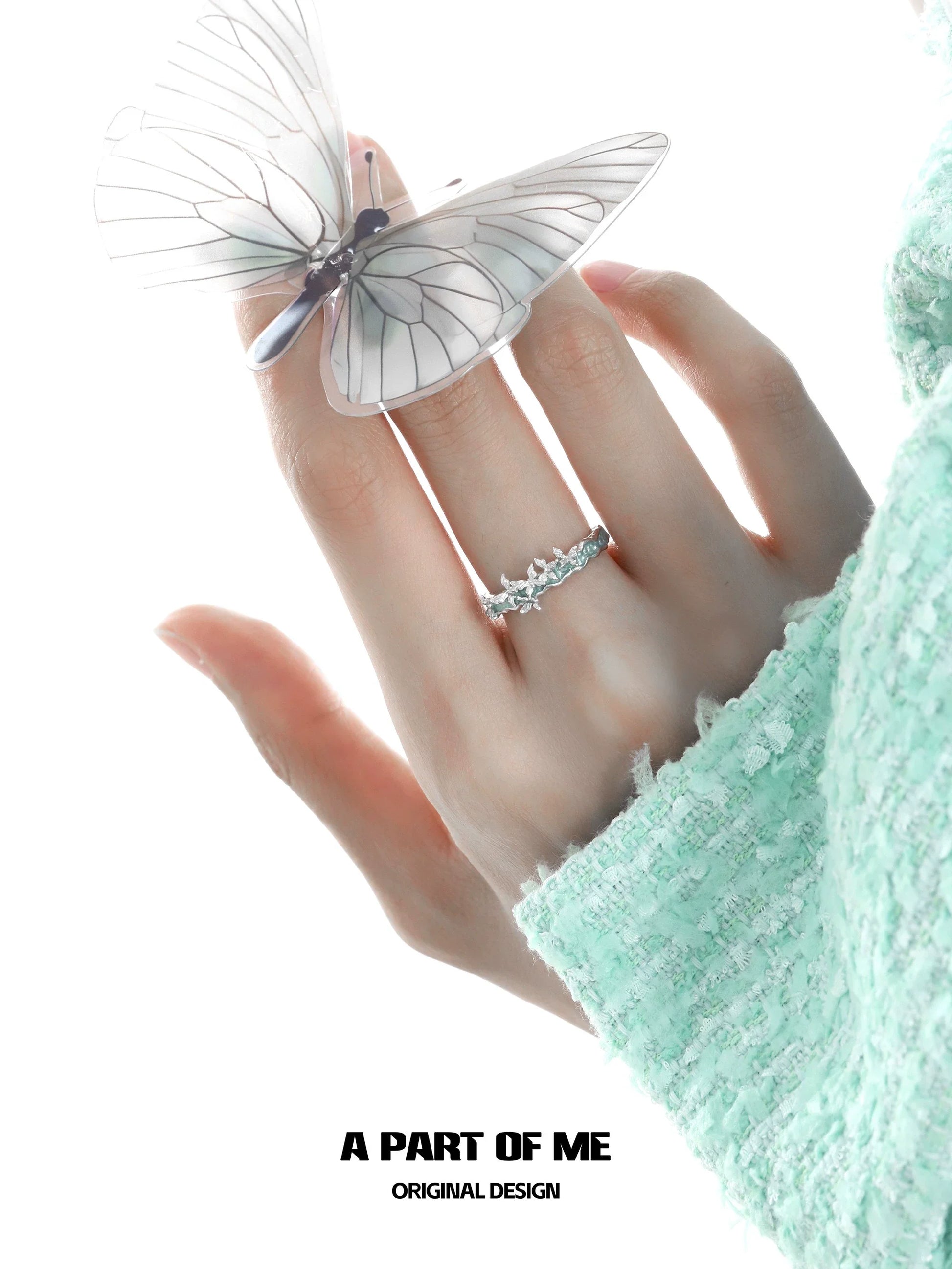 Mint butterfly ring from A PART OF ME showcased on a hand with a transparent butterfly accessory