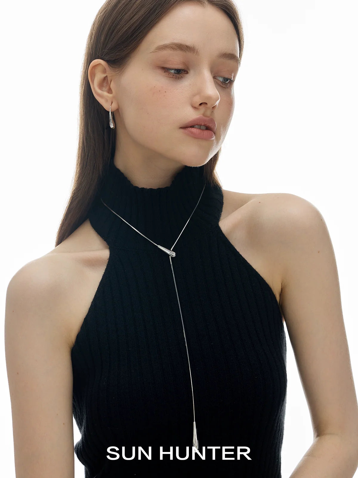 SUN HUNTER Molten Drop Necklace on a model wearing a black sleeveless top, showcasing elegant style