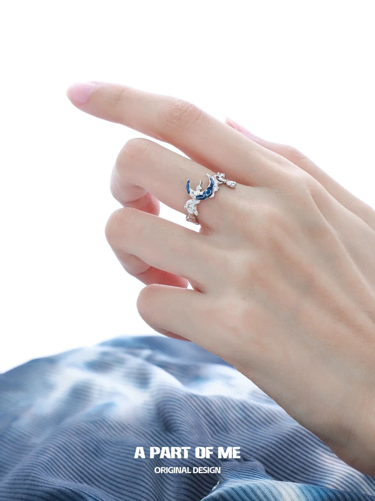 A PART OF ME Mystic Blue Moon Ring with intricate design showcased on a delicate hand