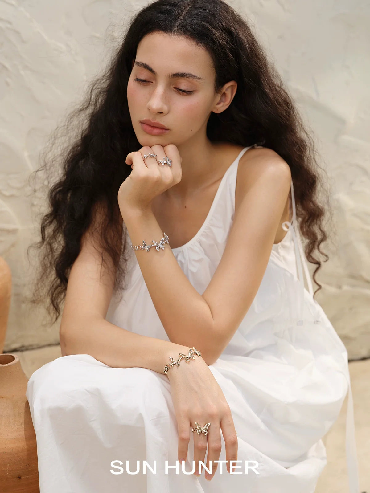 Model wearing a SUN HUNTER mystic butterfly ring with elegant styling for a chic look