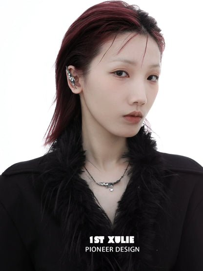 Model showcasing a mystic feather piercing earring in a stylish black outfit with a chic hairstyle